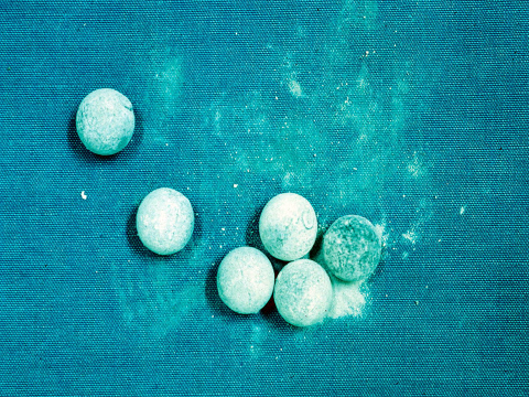 6 lead musket balls with white crumbled surface corrosion.